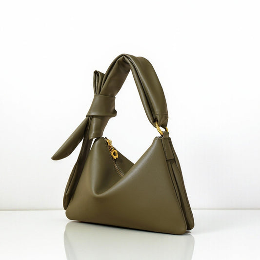 Green handbag with a unique design on a white background